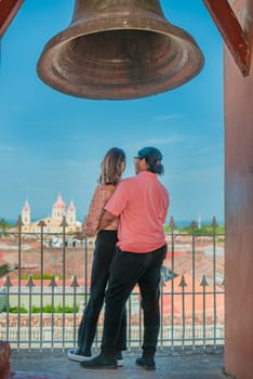 Young tourist couple looking at the Granada cathedral from the La Merced viewpoint. Tourist couple at the viewpoint of the La Merced church looking at the Granada cathedral