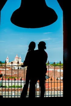 Silhouette of a tourist couple contemplating the Granada cathedral from the La Merced viewpoint