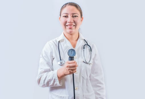 Young female doctor holding tensiometer on isolated background. Smiling female doctor showing blood pressure monitor isolated
