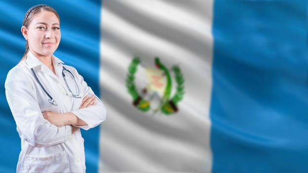 Female doctor with arms crossed with Guatemala flag background. Healthcare concept with Guatemalan flag in background