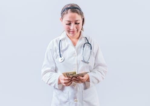 Corrupt female doctor counting money isolated. Female doctor counting banknotes on white background. Medical corruption concept