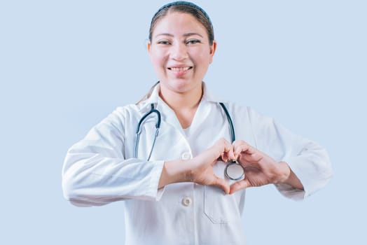 Smiling doctor making heart shape on isolated background. Friendly female doctor making heart gesture with hands isolated