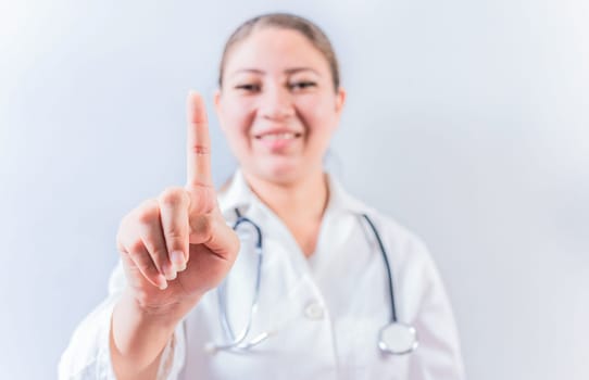 Female doctor counting number ONE isolated. Young female doctor counting number 1 on isolated background