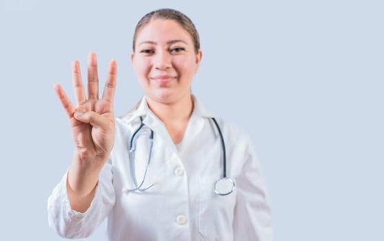 Female doctor counting number FOUR isolated. Young female doctor counting number 4 on isolated background