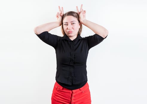 People making horns gesture with their fingers, gesture of betrayal. Young woman making horns gesture with fingers. Infidelity concept