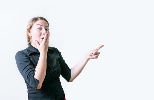 surprised young woman pointing an advertising isolated. Beautiful woman pointing to a banner to the side. Funny people pointing a promo isolated