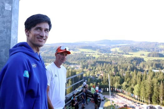 Martin Schmitt (TV pundit/ski jumping expert,Eurosport,former world champion) and men's national ski jumping coach Steffen Horngacher take a close look  at the FIS Cup Summer Ski Jumping Hinterzarten 2024