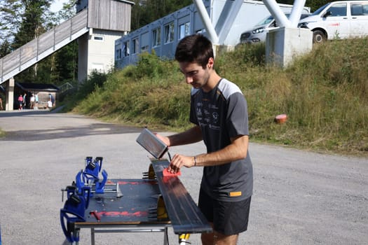At the junior competition "FIS Cup"",the ski jumpers still prepare their jumping slats themselves - at the FIS Cup Summer Ski Jumping Hinterzarten 2024"