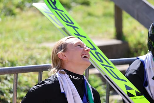 Katharina Schmid (SC Oberstdorf) celebrates her victory at the COC Cup Summer Ski Jumping Hinterzarten 2024