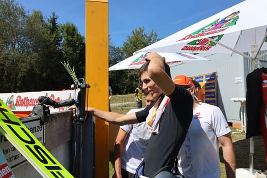 Will it be enough for the podium? Luca Roth (SV Messstetten) looks at the scoreboard and celebrates second place at the COC Cup Summer Ski Jumping Hinterzarten 2024
