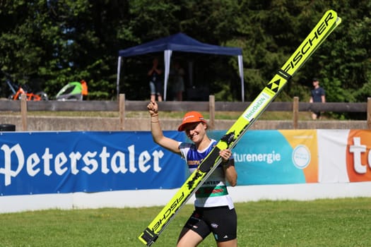 Enjoy the moment with the day's victory: Katharina Schmid (SC Oberstdorf) at the award ceremony for the COC Cup Summer Ski Jumping Hinterzarten 2024