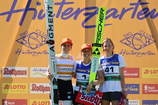 Beaming women at the award ceremony: v.li. Selina Freitag (WSC Erzgebirge Oberwiesenthal),Katharina Althaus (SC Oberstdorf) and Karolina Indrackova (Czech Republic/CZE) at the COC Cup Summer Ski Jumping Hinterzarten 2024