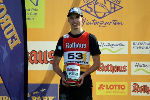 Luca Roth (SV Messstetten) is happy about second place and the keg of beer at the FIS Cup Summer Ski Jumping Hinterzarten 2024