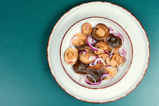 Salted mushrooms in a plate. Homemade marinated mushrooms.
