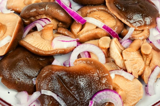 Salted mushrooms in a plate. Homemade marinated mushrooms.