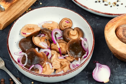 Salted mushrooms in a plate. Homemade marinated mushrooms.