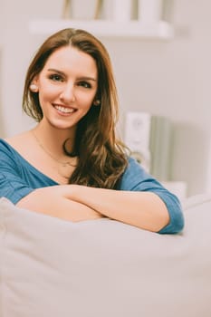 young woman with a peaceful smile, embracing both conceptual and non-conceptual awareness, sits comfortably. Her serene demeanor reflects her commitment to a balanced, happy, and mindful life