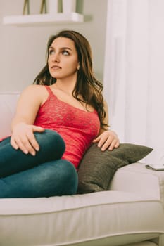 woman, seated with anticipation, gazes intensely off-camera, eagerly awaiting her passionate lover. Her poised yet tense posture reflects her longing and excitement for the imminent reunion