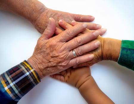 A tower of hands from people of different ages