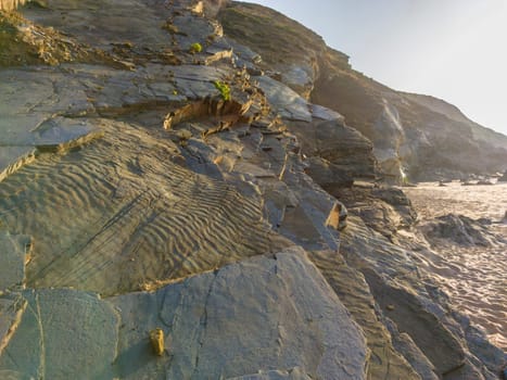 Fossil traces visible in a layer of detached rock. Nossa Senhora beach, Zambujeira do Mar, Odemira, Portugal