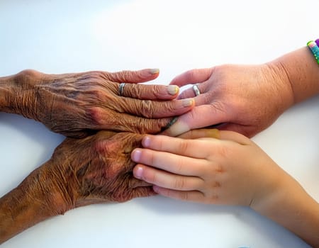 A tower of hands from people of different ages