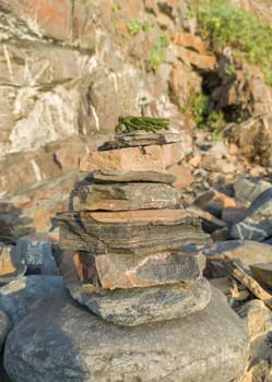 Stones stacked in the shape of a totem on the beach of Nossa Senhora beach, Zambujeira do Mar, Portugal