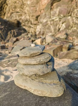 Stones stacked in the shape of a totem on the beach of Nossa Senhora beach, Zambujeira do Mar, Portugal
