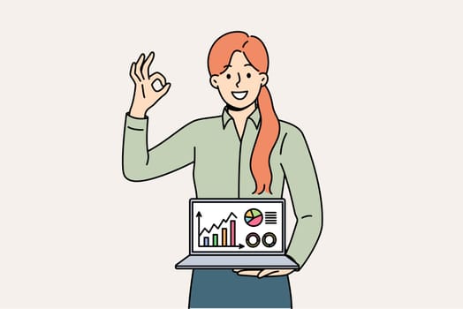 Business woman shows laptop with diagrams and ok gesture, reporting success of startup and income growth. Statistical data in computer of girl investor recommending using crm for business