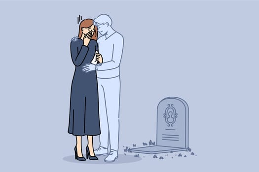 Ghost of husband supports widow crying at grave of deceased groom and suffering from loneliness. Widow girl stands in despair near gravestone in cemetery and needs help from loved ones