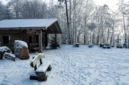 A log cabin in winter with lots of snow and trees