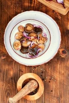 Salted mushrooms in a plate. Fermented healthy food. Homemade pickled mushrooms.