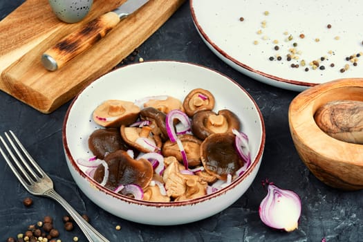 Salted mushrooms in a plate. Fermented healthy food. Homemade pickled mushrooms.