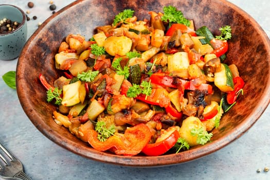 French vegetable dish, ratatouille. Baked eggplants or zucchini, peppers and tomatoes.