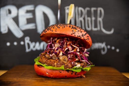 Fresh colorful vegan burgers with vegetables on counter at summer local food market - close up view. Outdoor cooking, gastronomy, vegetarian, street food concept
