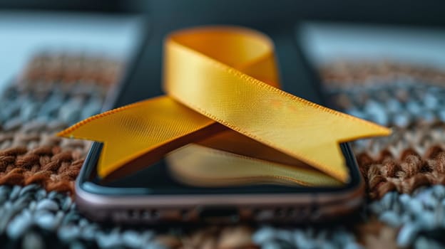 Close-up of a smartphone with a gold ribbon promoting awareness about childhood cancer online.