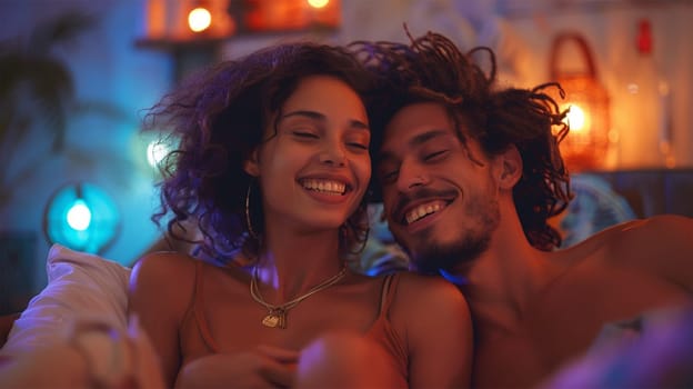 Smiling couple cuddling and enjoying a cozy evening together at home, with warm and colorful ambient lighting