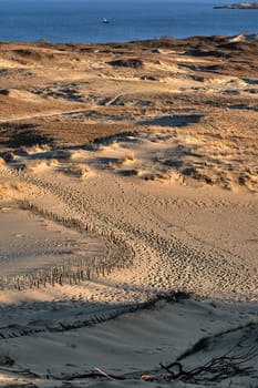 Early spring nature of nordic dunes, Baltic sea and Curonian spit, Nida, Klaipeda, Lithuania at sunset. Lines, rhythm and patterns of shadows and hills