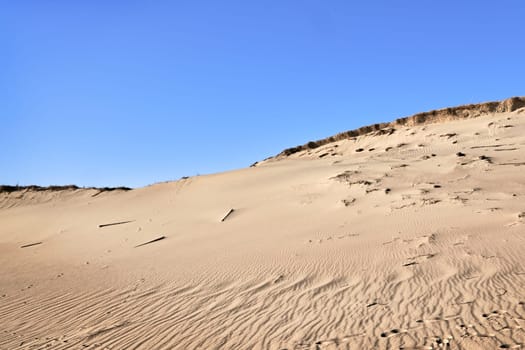 Nordic dunes, Baltic sea, Curonian spit, Nida, Klaipeda, Lithuania at sunset. Lines, rhythm and patterns of shadows and hills