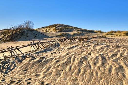 Nordic sand dunes, Baltic sea, Curonian spit, Nida, Klaipeda, Lithuania at sunset. Lines, rhythm and patterns of shadows