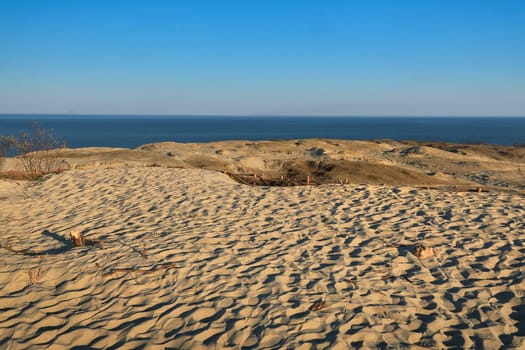Nordic sand dunes, Baltic sea, Curonian spit, Nida, Klaipeda, Lithuania at sunset. Lines, rhythm and patterns of shadows and hills