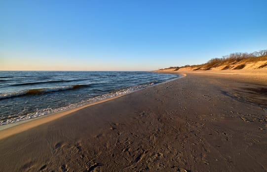 Beautiful, ethereal, calm sunset at Baltic sea and nordic sand dunes of Curonian spit, Nida, Lithuania