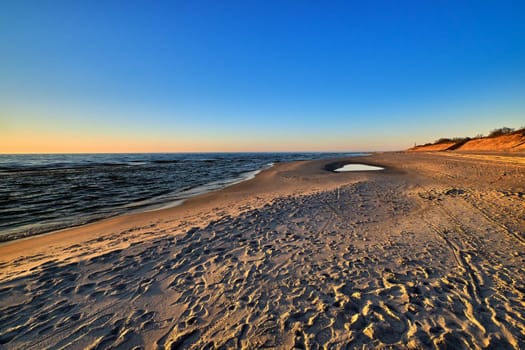 Beautiful, ethereal, calm sunset at Baltic sea and nordic sand dunes of Curonian spit, Nida, Lithuania