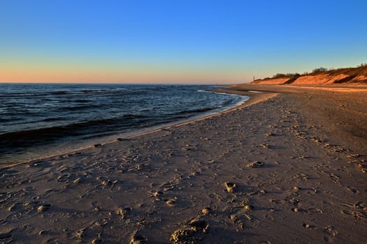 Beautiful, ethereal, calm sunset at Baltic sea and nordic sand dunes of Curonian spit, Nida, Lithuania