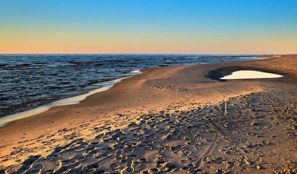 Beautiful, ethereal, calm sunset at Baltic sea and nordic sand dunes of Curonian spit, Nida, Lithuania