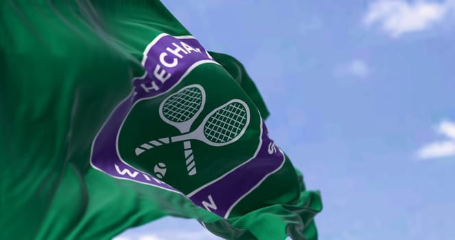 London, UK, May 2023: Flag with The Championships Wimbledon logo waving in the wind. Wimbledon Championships is a major tennis tournament. Illustrative editorial 3d illustration render.