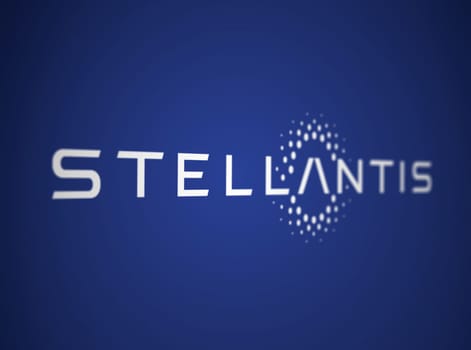 Amsterdam, NL, May 2023: White Stellantis logo on a blue background. Multinational automotive manufacturing corporation. Illustrative editorial. Illustration. Selective focus