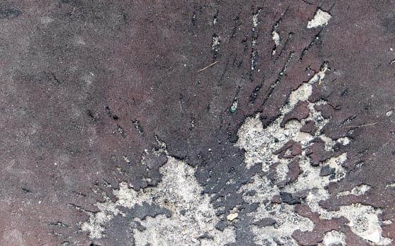 War in Ukraine. Funnel from the explosion in the asphalt. The trace left by the explosion of an artillery shell. Consequences of the rocket attack