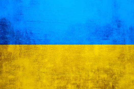 The wall is in the colors of the Ukrainian national flag - blue and yellow. Abstract texture background of concrete stone wall. Ukrainian flag on a grunge wall in connection with the war with Russia