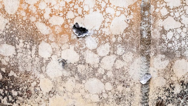 Hole or hole, armor deformation from a projectile close-up. Damaged armor of a Russian armored personnel carrier by shell fragments. War in Ukraine. Russian combat vehicle with holes in the armor