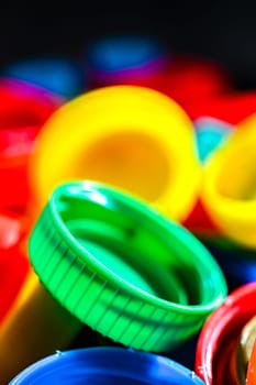 Different sorts of colorful plastic bottle caps. Recycling.